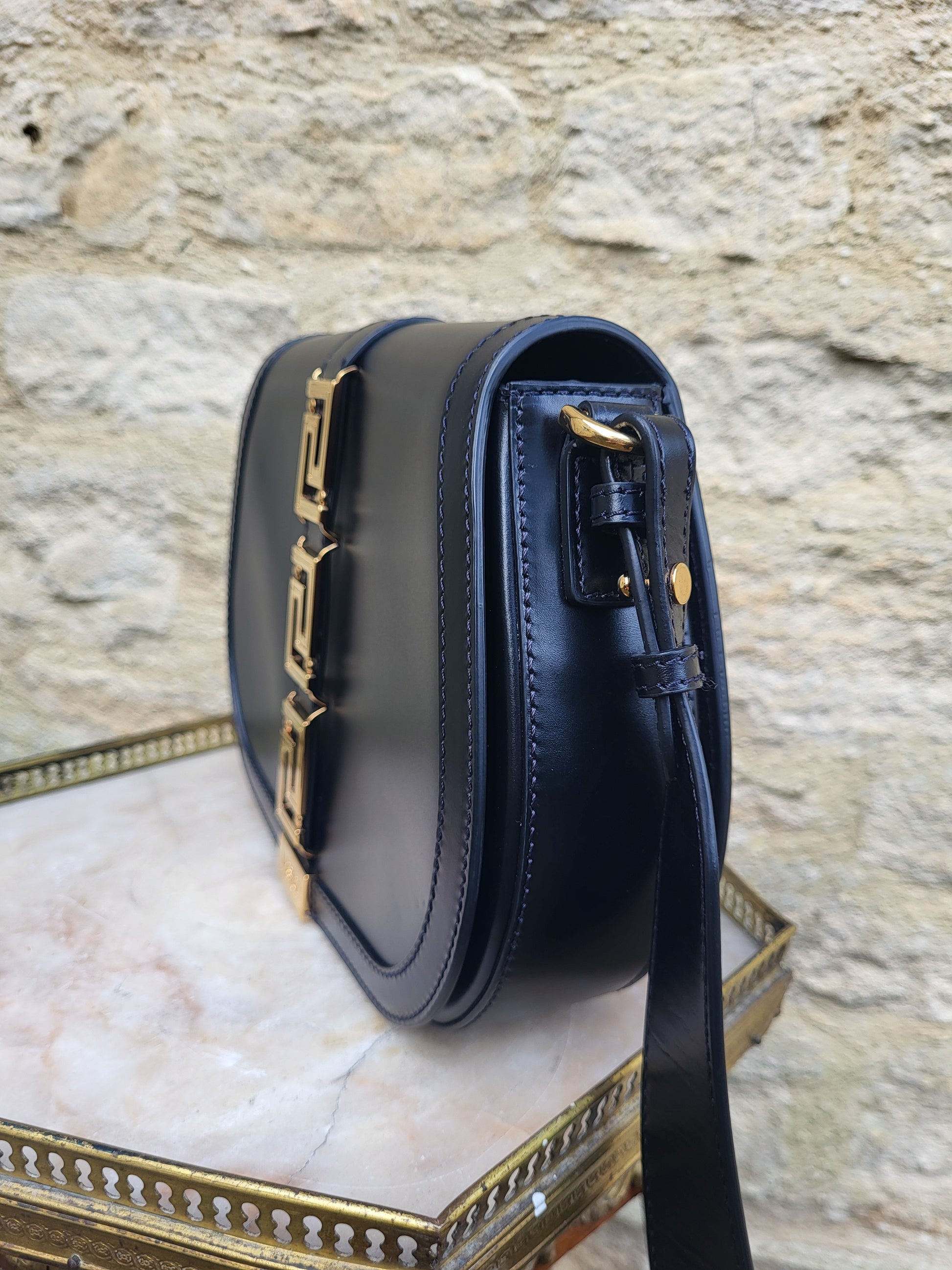Versace Greca Goddess black leather crossbody bag, brand new with tags. Angular side view.